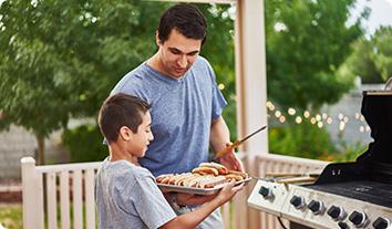 a man and a boy holding a plate of food