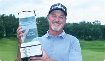 Jerry Kelly holding up a couple of books