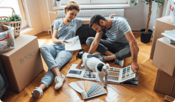 a couple and their dog relaxing on the floor of their home