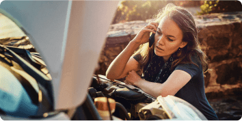 a woman on the phone with a stranded car