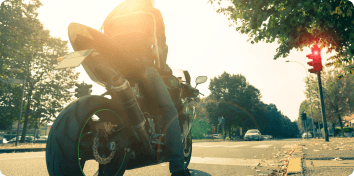 a person on a motorcycle at a stoplight