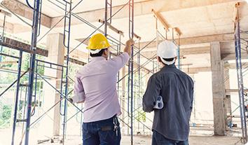 men wearing hard hats working on a construction site