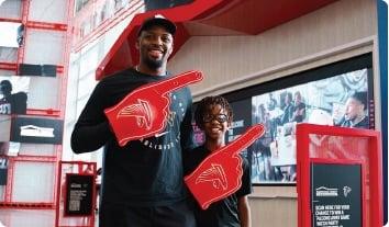 a man and woman holding a red and black flag