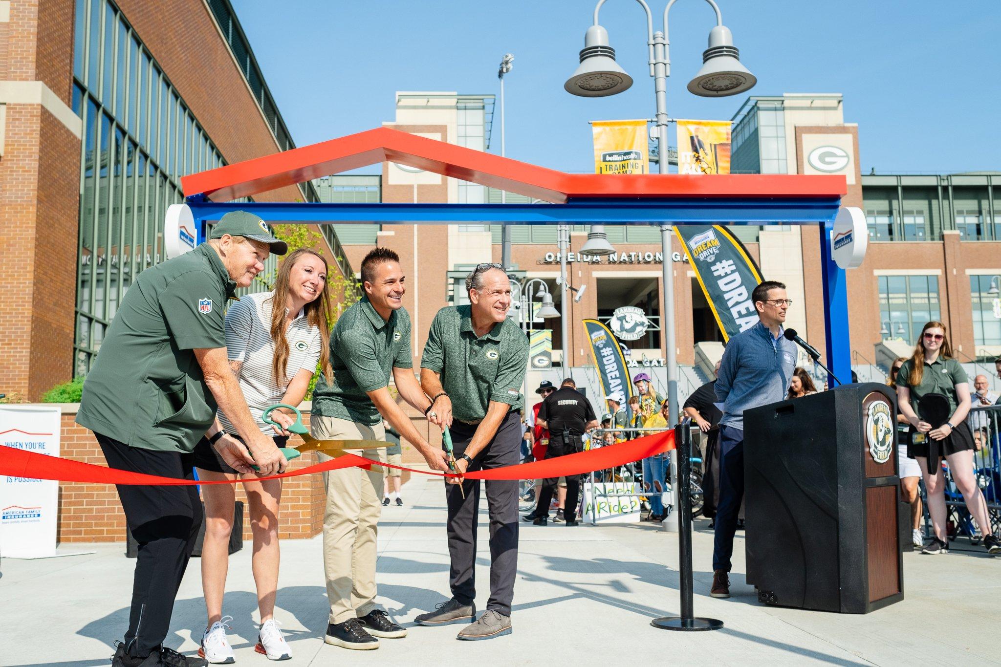 American Family Insurance and Green Bay Packers  personnel cutting ribbon.