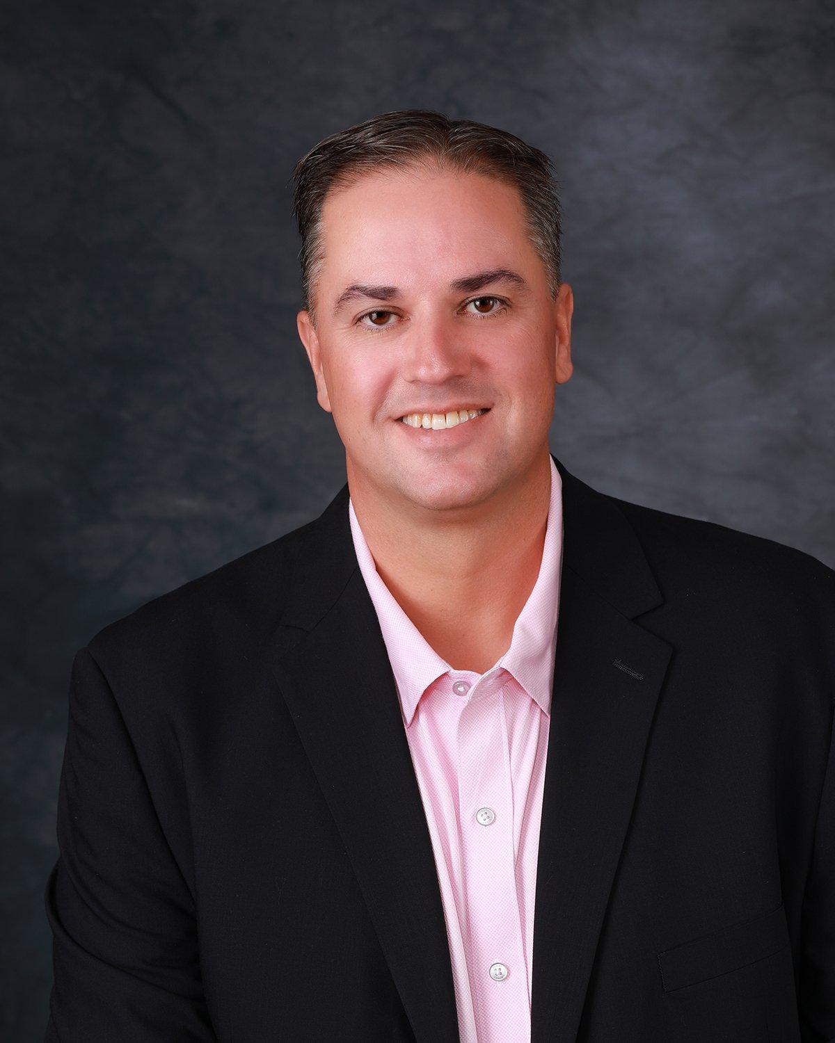 a man in a suit smiling