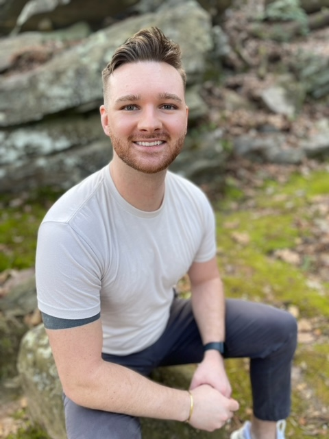 a man sitting on a rock