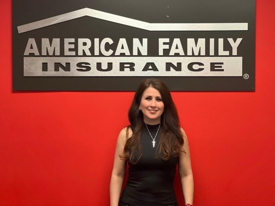 a woman standing in front of a sign