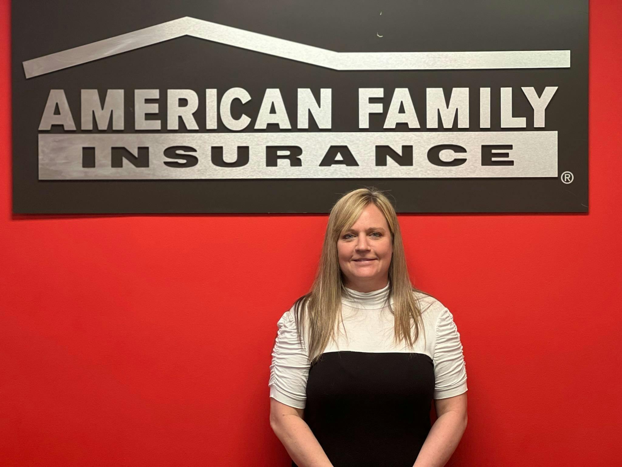 a woman standing in front of a sign