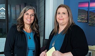 a couple of women smiling