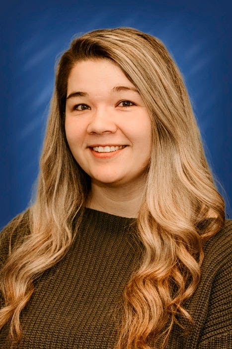 a woman with long hair smiling