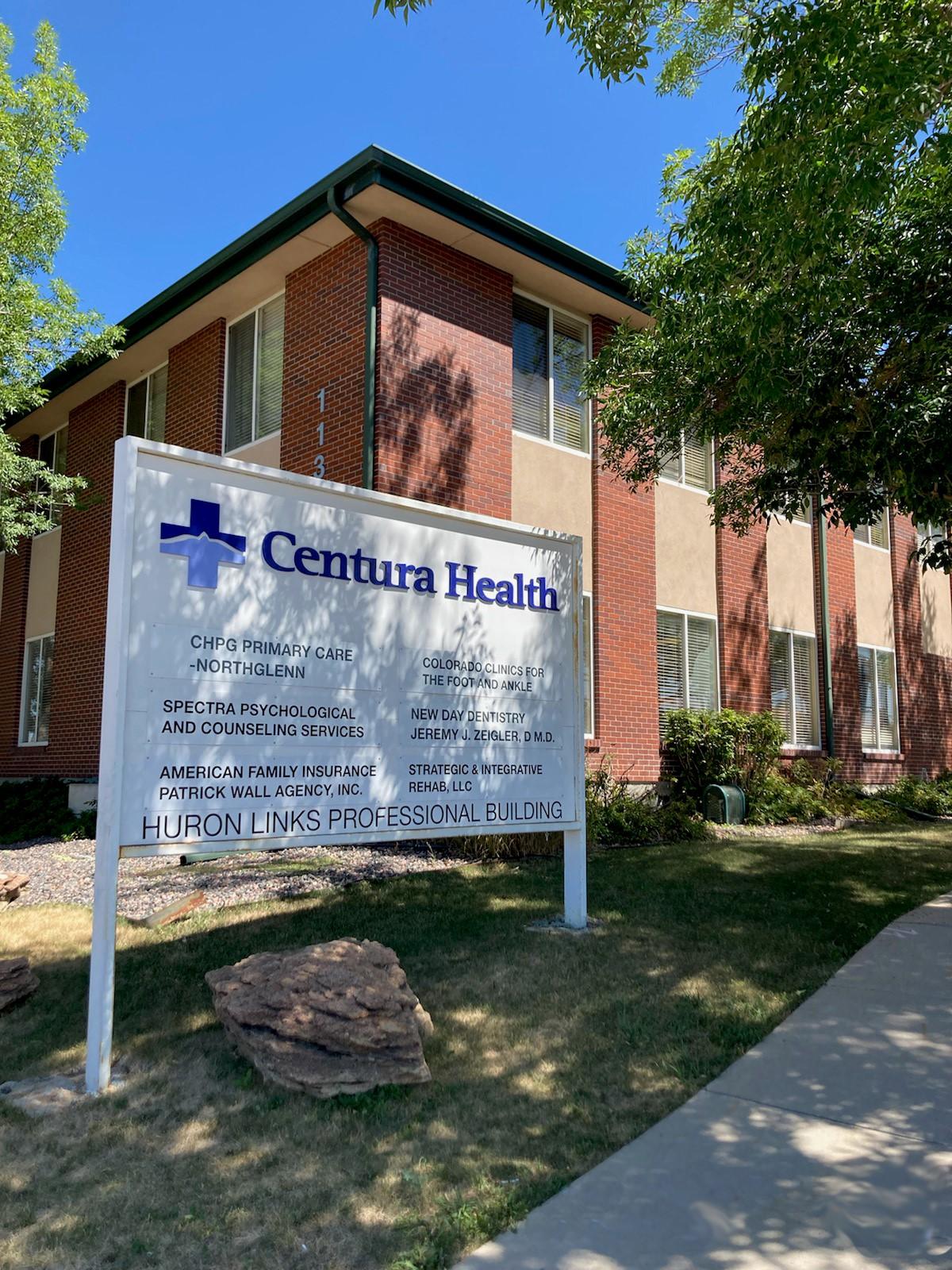 a sign in front of a brick building