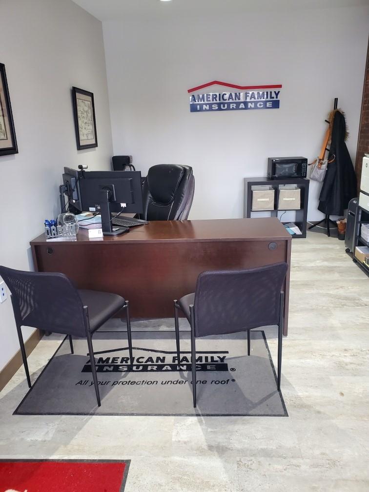 a desk with chairs and a computer