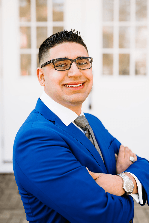 a man wearing glasses and a blue suit