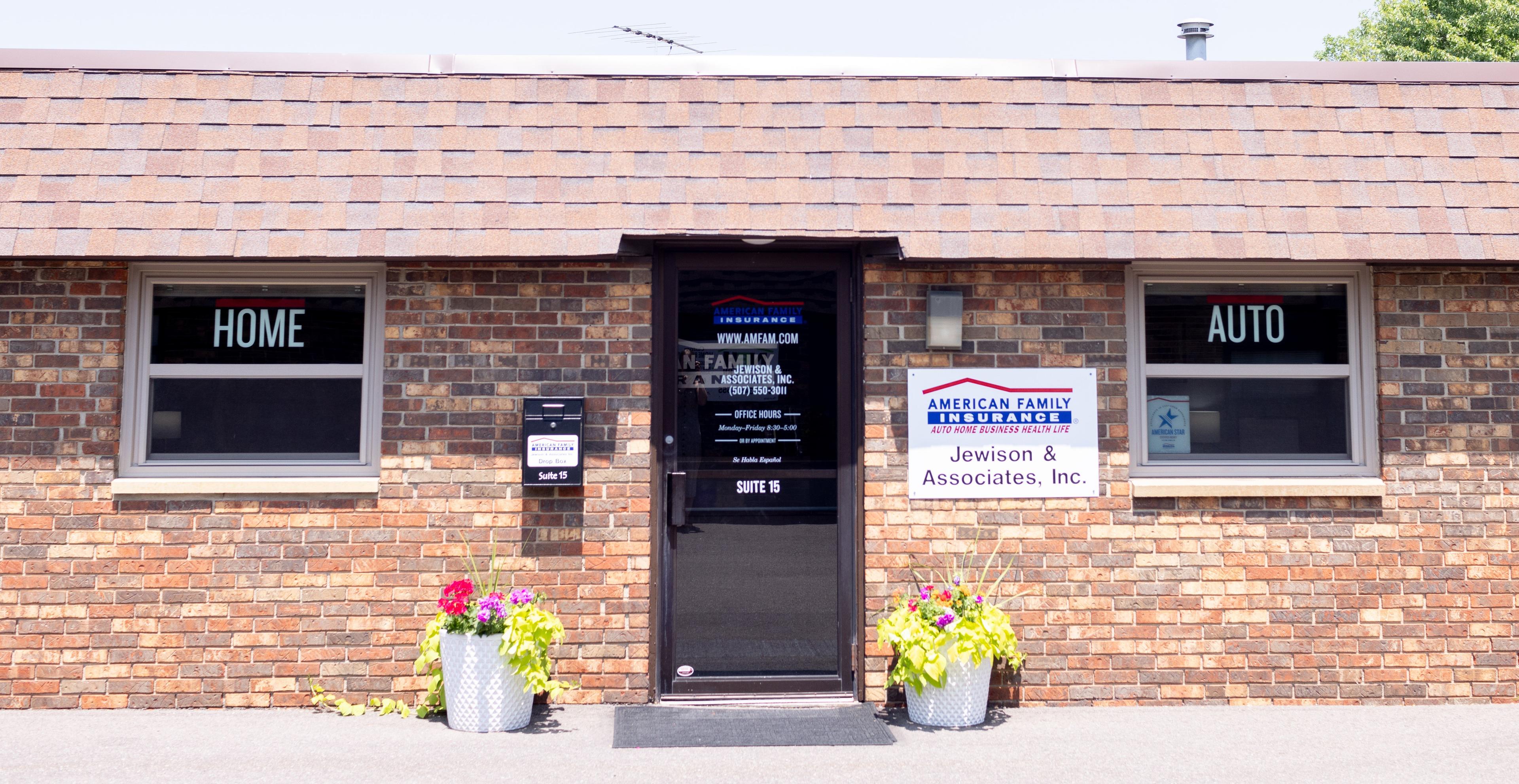 a brick building with a black door and windows