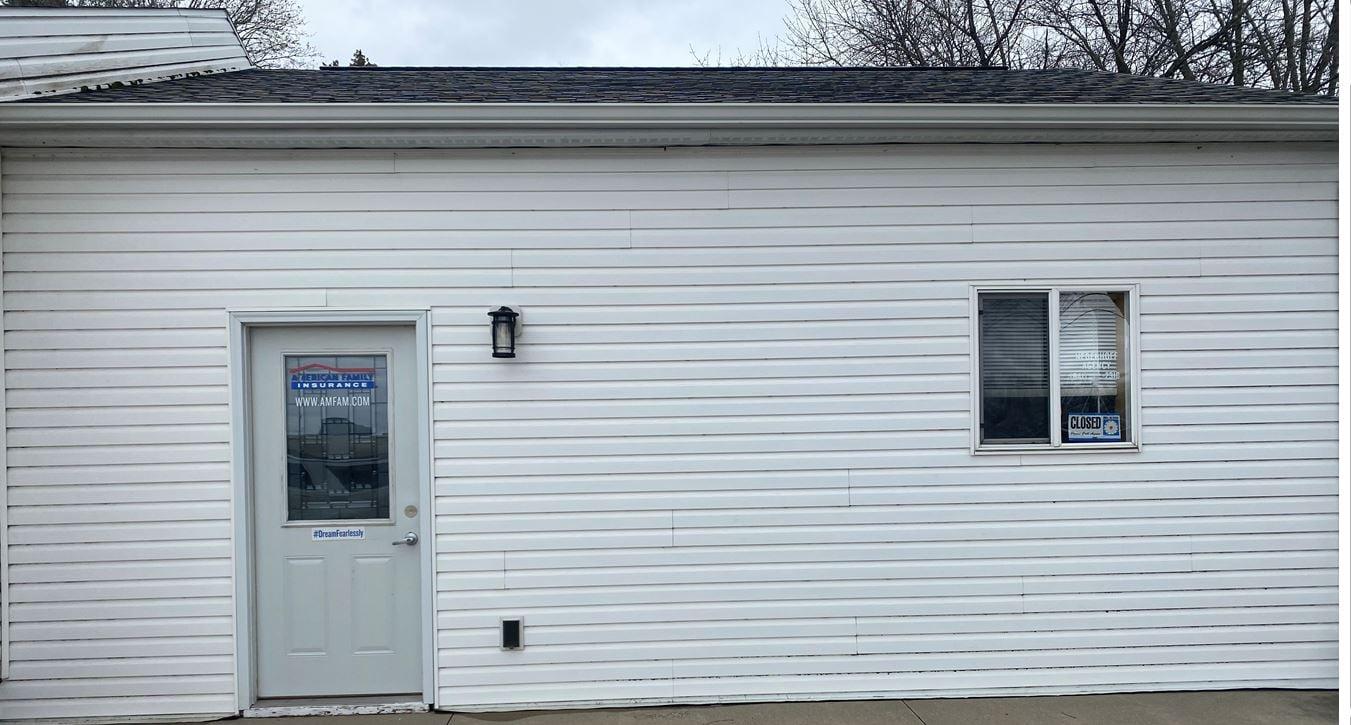 a white building with a door and windows