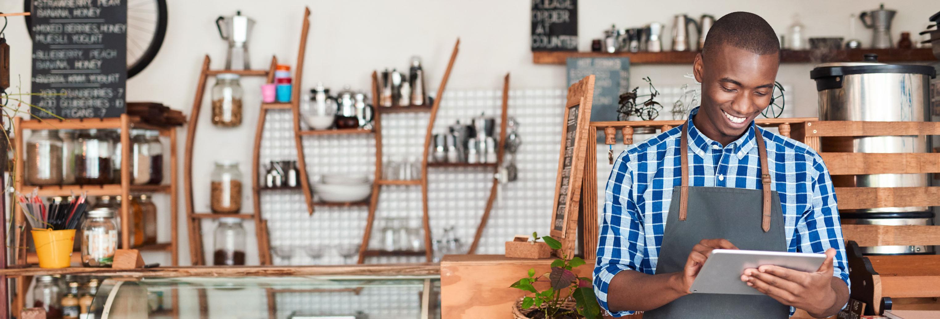 a man with a tablet in a shop