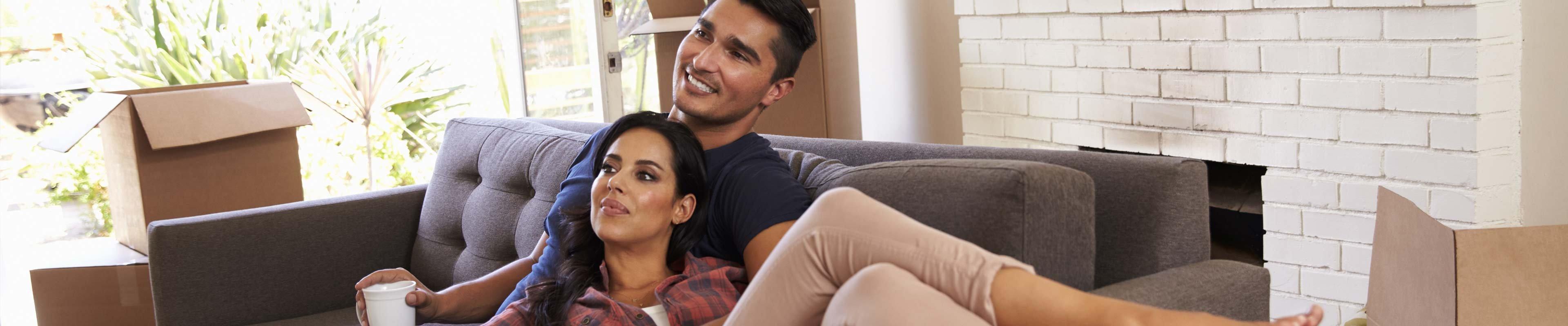 Image of couple with packing boxes in living room.