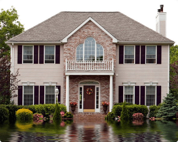 A house with flood waters rising at its door.