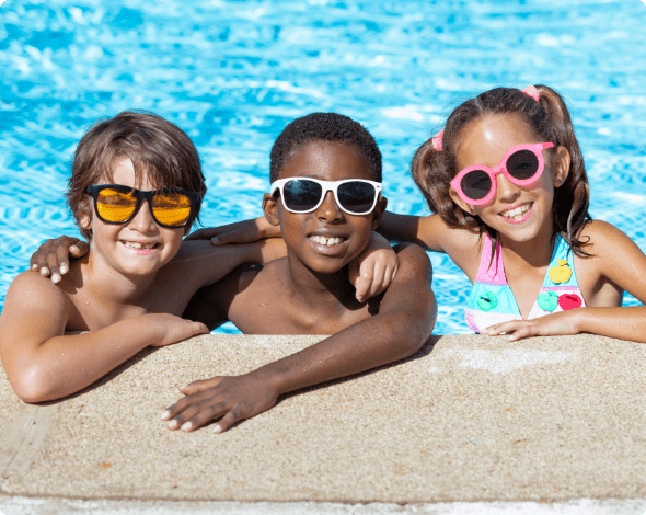 Smiling kids in their home's pool.