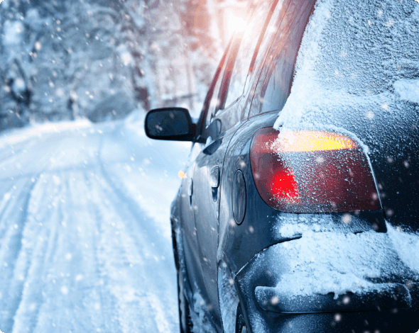 Car driving on a snow-covered road. 