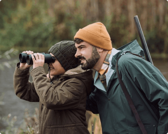 Couple hunting in a field. 