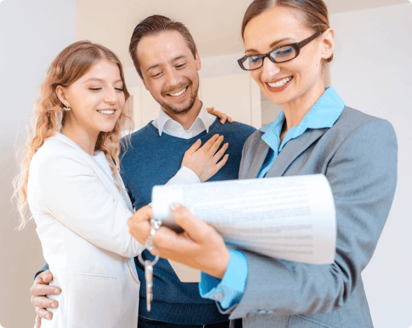 A couple reviewing housing details with a realtor.