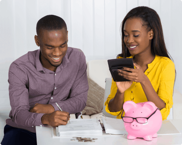 Couple sitting at a desk creating a budget. 