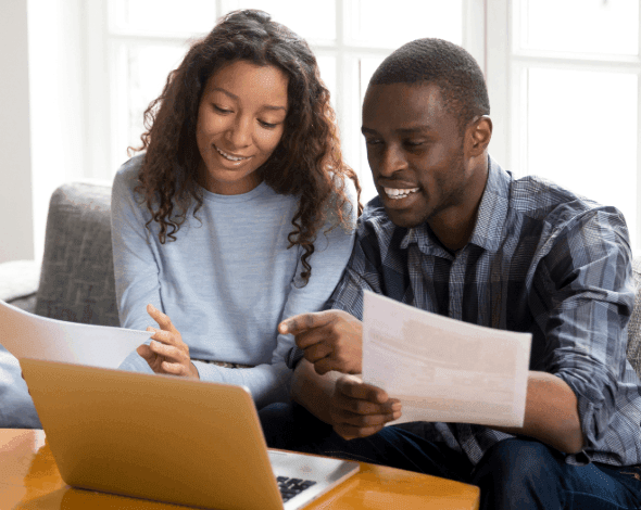 A happy couple reviewing documents.