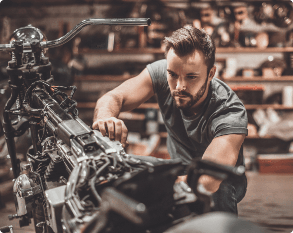 A person working on their bike in a shop.