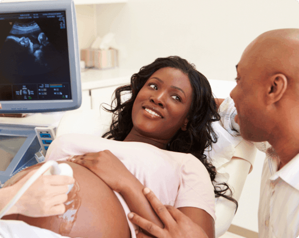 A happy couple getting an ultrasound. 