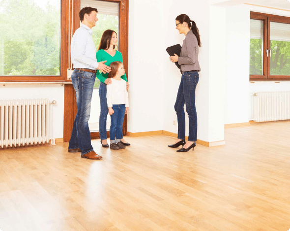 a couple and their child viewing a home with a realtor