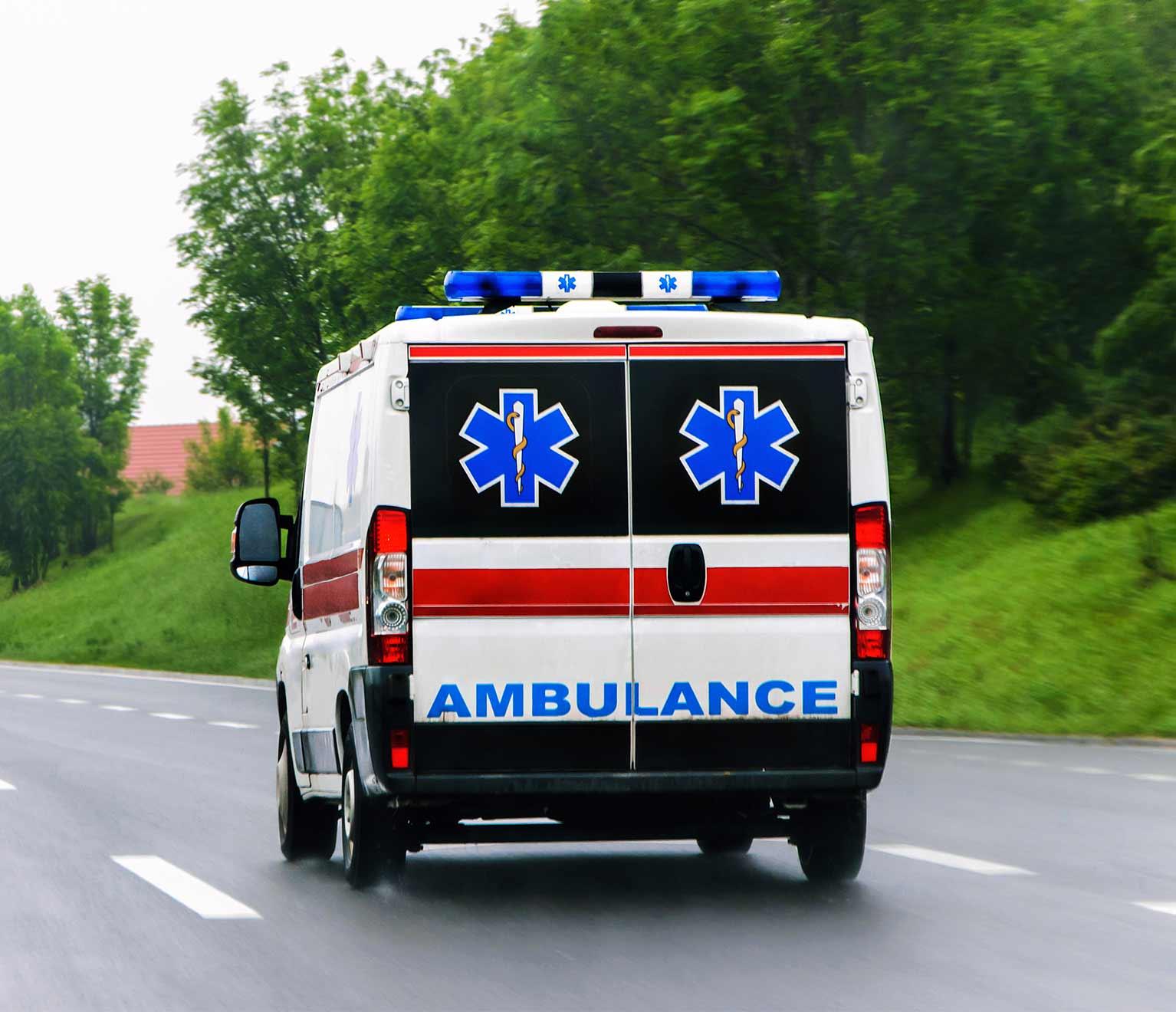 Ambulance on road with volunteer EMT.