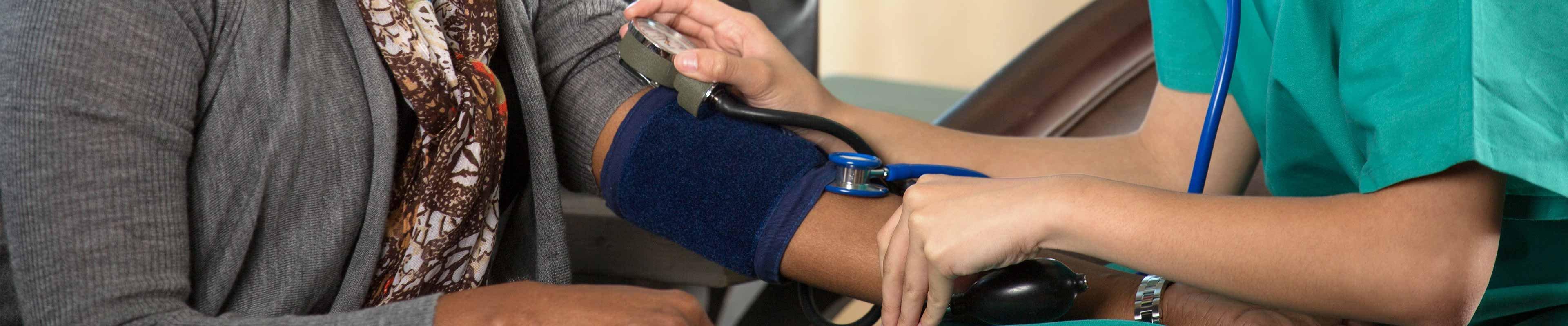 A nurse giving a life insurance medical exam.