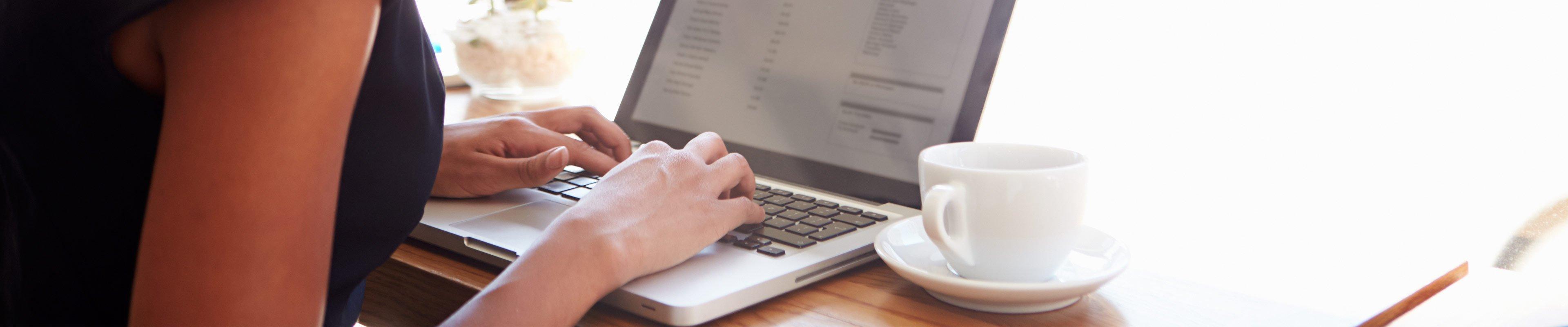 woman using a laptop in a coffee shop