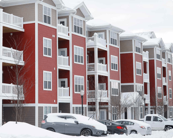 Apartment complex and parking lot covered in snow