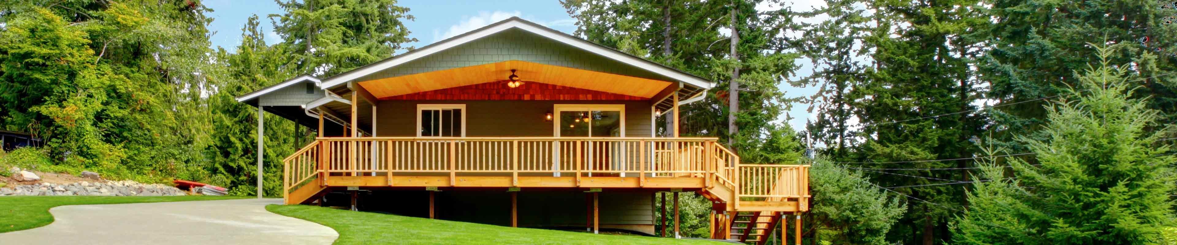 house with wraparound porch in the woods