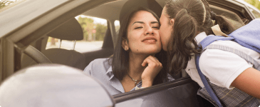 a girl giving her mom a kiss goodbye