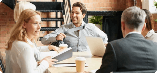 A few coworkers having a team meeting around a table