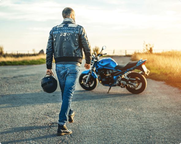 a man walking towards a motorcycle