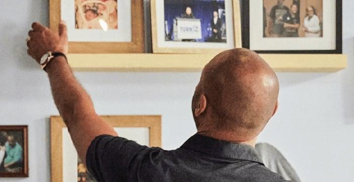 a man holding a wooden shelf