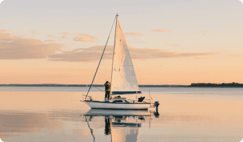 a person standing on a sailboat