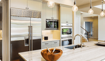 a kitchen with a stainless steel refrigerator