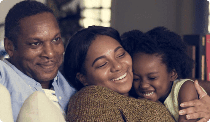 Family sitting and smiling on the couch